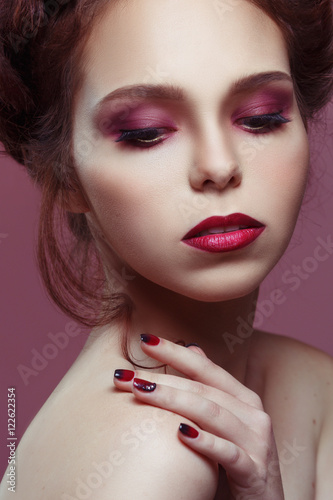 Beauty portrait of beautiful girl with languid gothic make-up on a violet background
