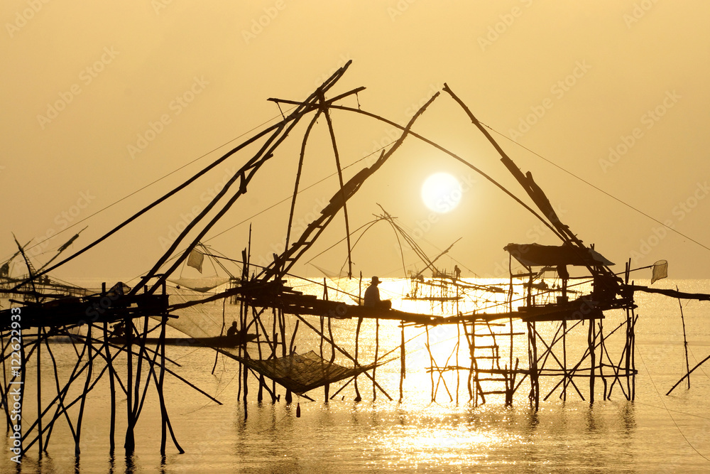 Silhouette of bamboo machinery in the lake. South of Thailand.