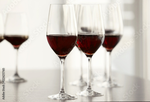 Glasses with red wine in a row on a table