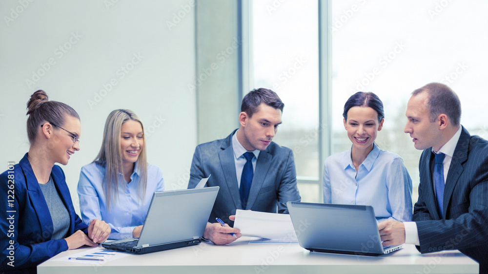 business team with laptop having discussion business team with laptop having discussion