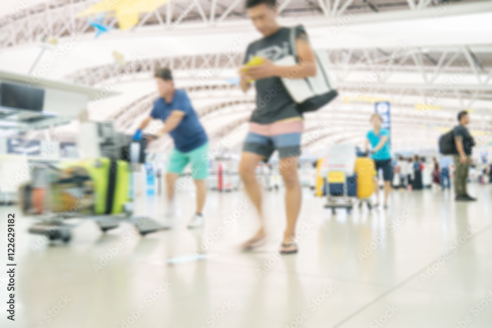 Blurred image of people traveling at airport terminal, People checking in at airport terminal with motion blur
