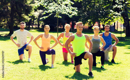 group of friends or sportsmen exercising outdoors