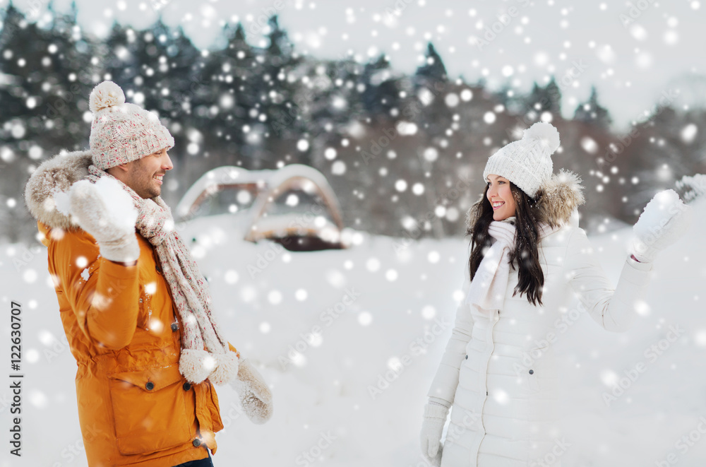 happy couple playing snowballs in winter happy couple playing snowballs in winter