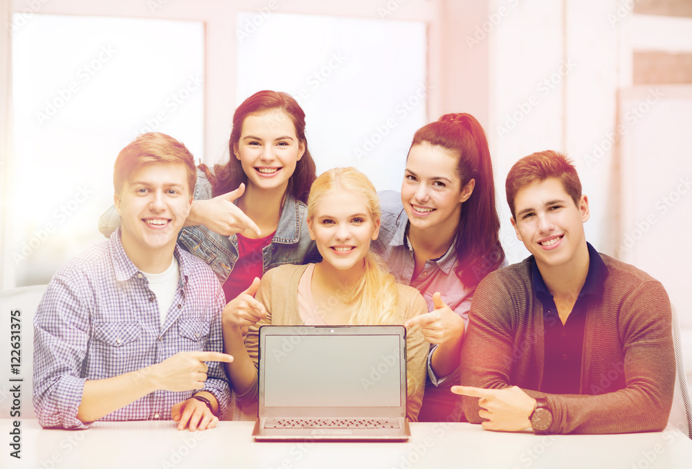 smiling students pointing to blank lapotop screen smiling students pointing to blank lapotop screen