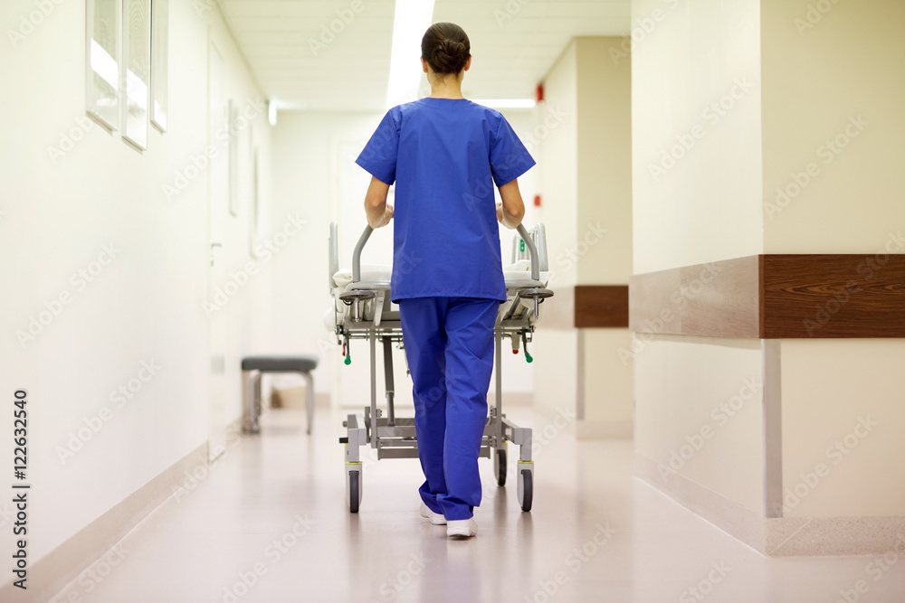 nurse carrying hospital gurney to emergency room nurse carrying hospital gurney to emergency room