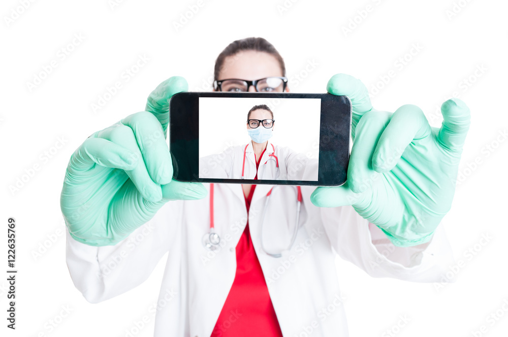 © Catalin Pop - Woman doctor with googles and smartphone