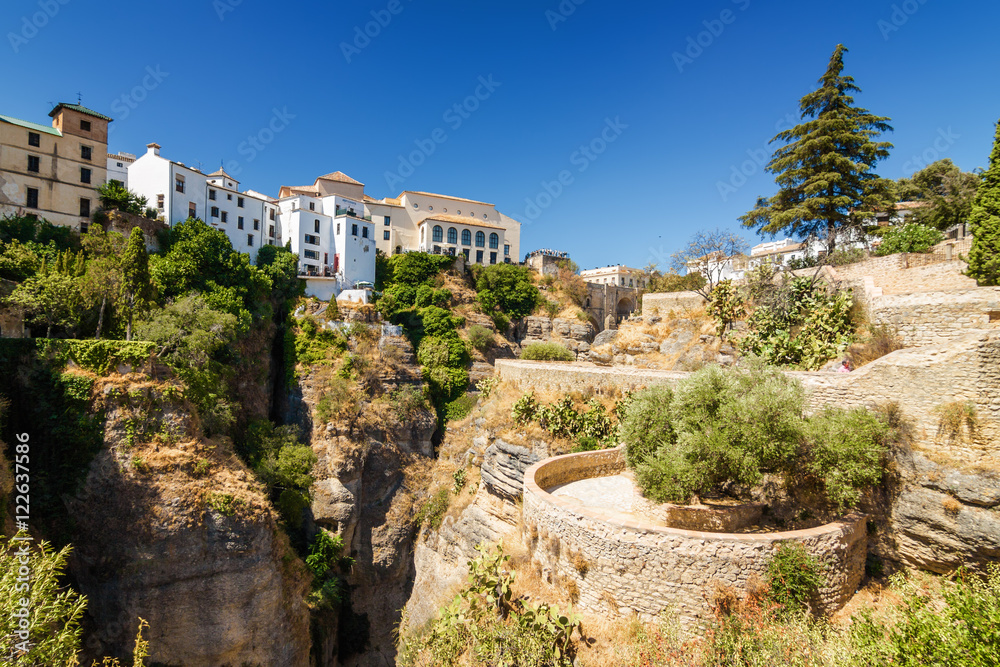 Buildings and viewpoint on the cliffside of El Tajo Gorge in Ronda, Malaga province, Spain.