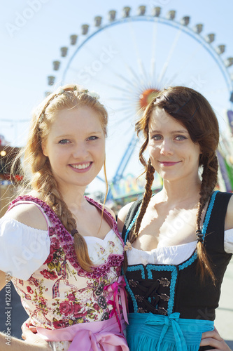 German girls wearing traditional dirndl at Oktoberfest 