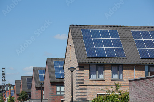 Modern houses with solar panels on the roof for alternative ener