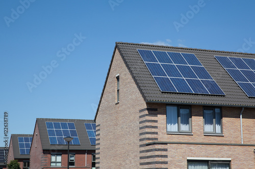 Modern houses with solar panels on the roof for alternative ener