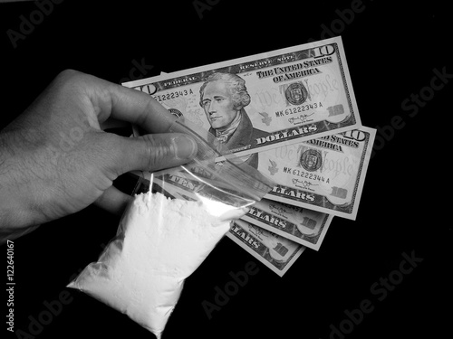 Men holding bag with cocaine drug powder and US money, dollar bills cash, men selling drugs junkie in black and white colors