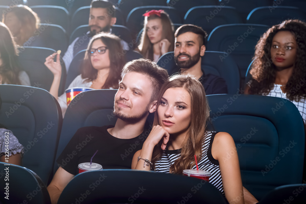 Young happy couple having a date at the cinema