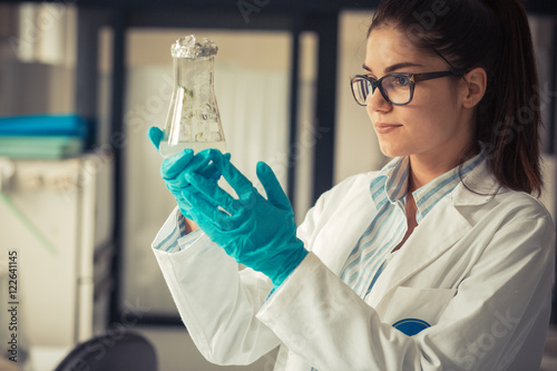 Young female geneticist looking in plant samples.Agricultural laboratory. photo