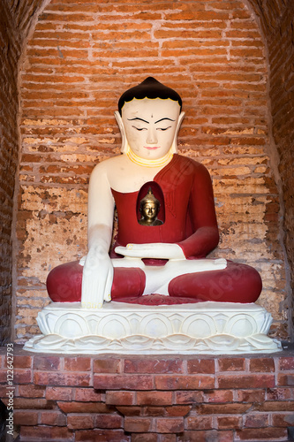 Buddha statue inside Seinnyet Ama Pagoda ruins. Ancient architecture of old Buddhist Temples at Bagan Kingdom  Myanmar  Burma 