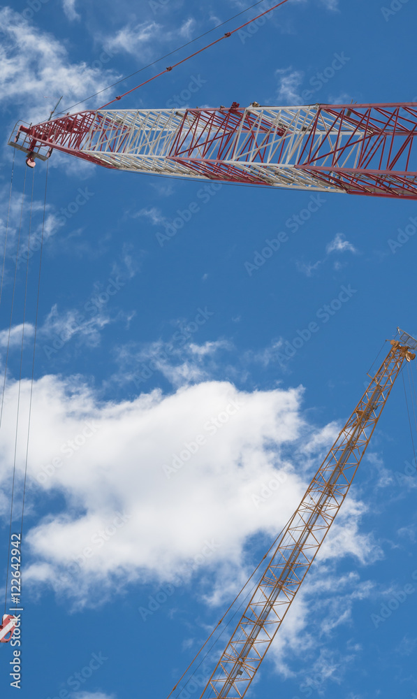 Industrial construction crane against blue sky background Industrial construction crane against blue sky background
