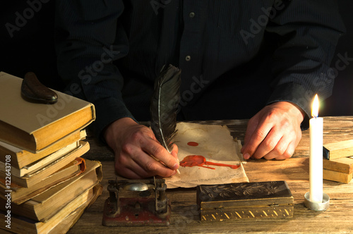 Man writing a letter with quill and sealing. Vintage