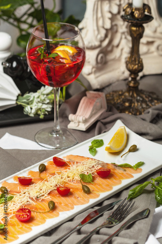 carpaccio of salmon with cherry tomatoes and wine and Aperol