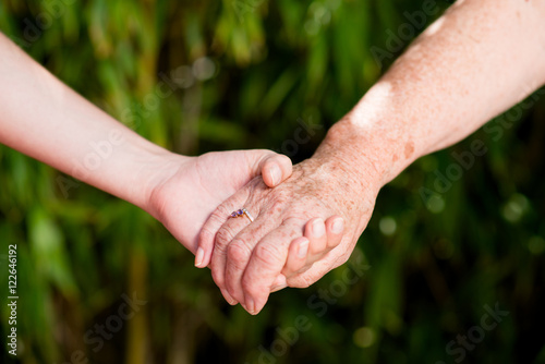close up of young woman hand holding with tenderness an elderly senior person hands © W PRODUCTION
