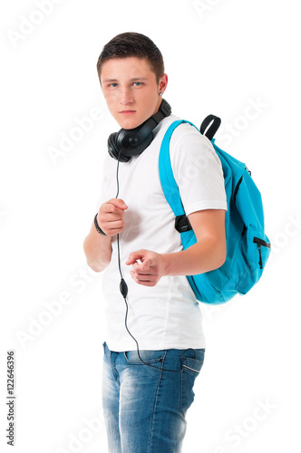 Teen student boy with headphones and backpack. Guy pointing at camera choosing you, isolated on white background. Portrait of young man pointing forefinger to front, gesture and people concept.