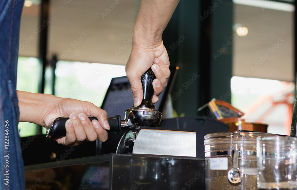 man presses the coffee for the coffee machine