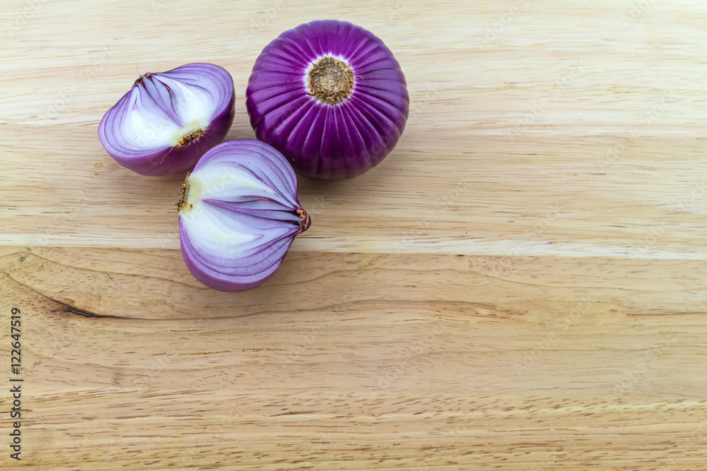 Red and purple sliced onion on wooden block Red and purple sliced onion on wooden block