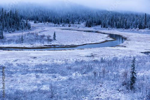 First autumn snow and the river in mountains photo