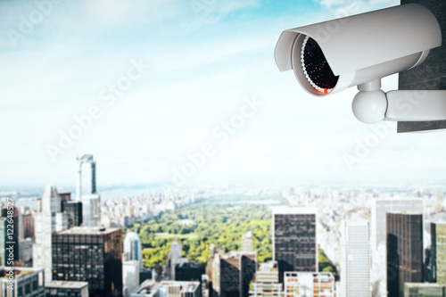 Security camera on contemporary city background
