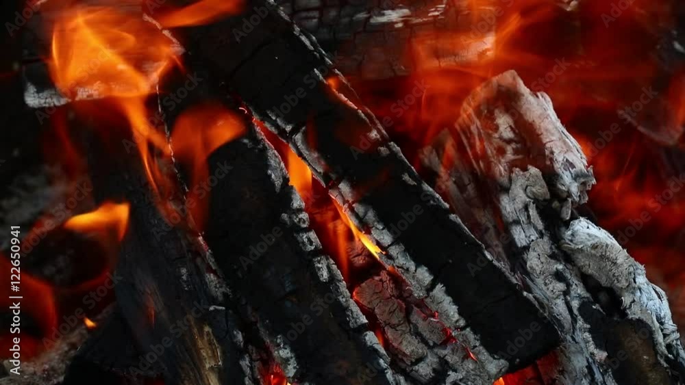 Blaze of bonfire, wood fire flame heat spires burning in fireplace with smoke and trembling in the wind and hot air flow, close up Blaze of bonfire, wood fire flame heat spires burning in fireplace with smoke and trembling in the wind and hot air flow, close up