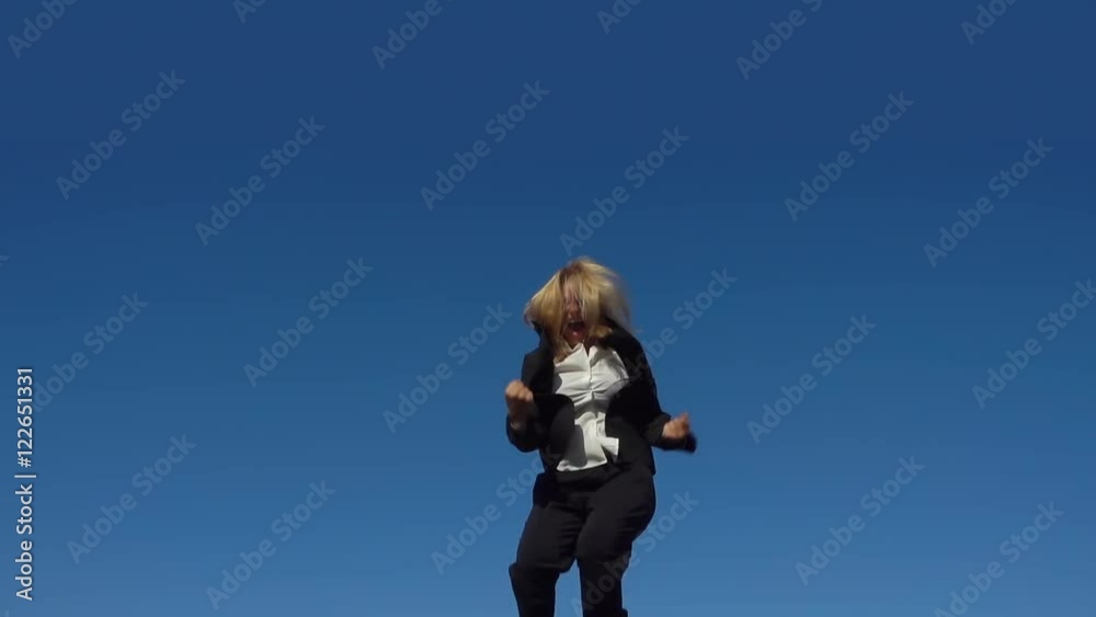 happy excited businesswoman jumping into blue sky celebrating arms outstretched slow motion happy excited businesswoman jumping into blue sky celebrating arms outstretched slow motion
