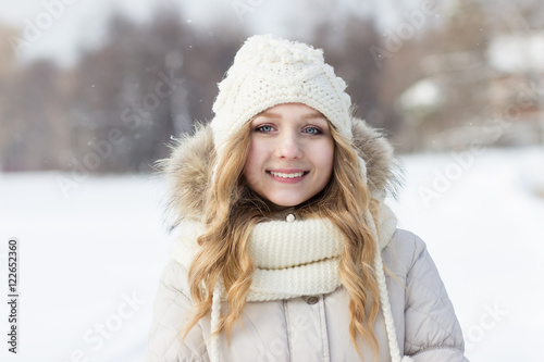 Close portrait of blonde girl in woolen hat, winter, outdoors. © tafiphoto