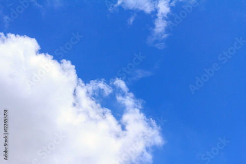 Blue sky background with white clouds. The vast blue sky and clouds sky on sunny day. White fluffy clouds in the blue sky.