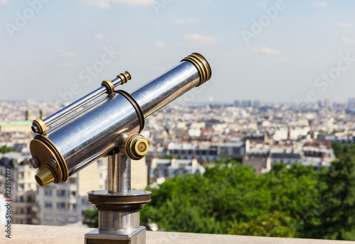 Touristic telescope overlooking Paris from Montmartre hill. Pari