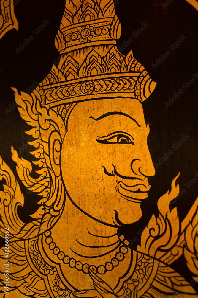 god in Thai style hand painting art golden color on window of the temple god in Thai style hand painting art golden color on window of the temple