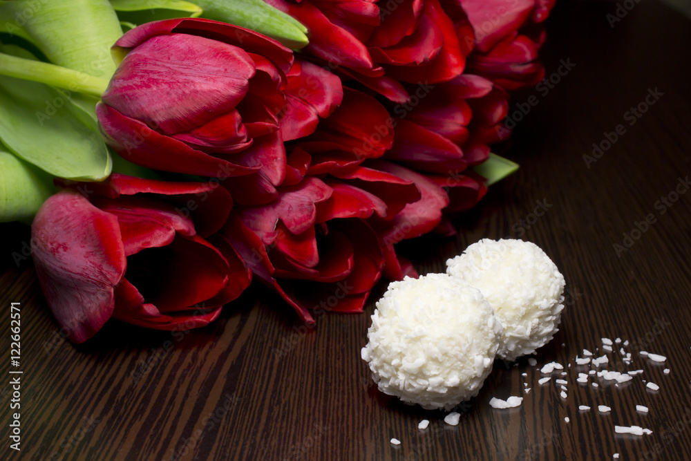 Tulips on a wooden background and sweets Tulips on a wooden background and sweets