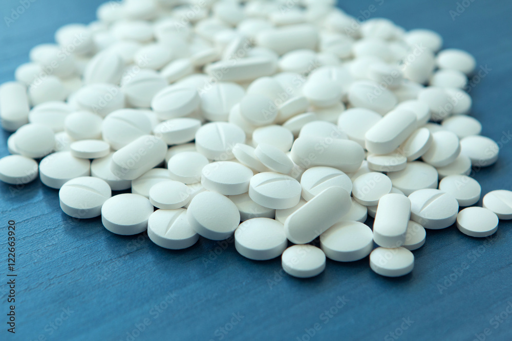 Top view of the Spilled white pills Top view of the Spilled white pills