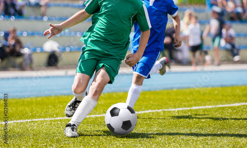 Soccer Players In Action. Football Players Running On The Field