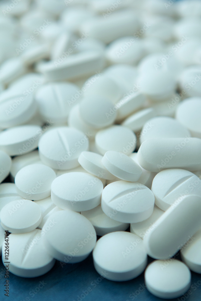 Top view of the Spilled white pills Top view of the Spilled white pills