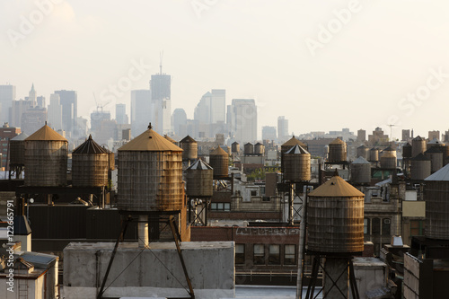 Water towers on roof tops in city photo