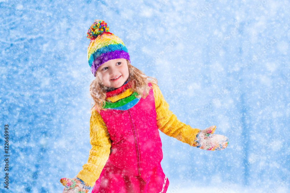 Little girl playing in snowy park Little girl playing in snowy park