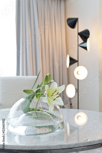 Lily and glass vase with upright lamp 