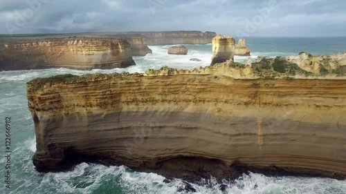 Smooth sideways flight showcasing the Razorback rock formation.  Great Ocean Road, Victoria, Australia.