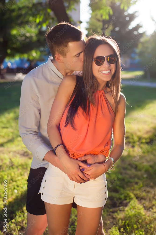 Close up romantic beauty portrait of happy hipster couple in love hugs and having fun, evening sunlight, stylish sunglasses, emotions, joy, youth, sunny colors, hugs and kisses.