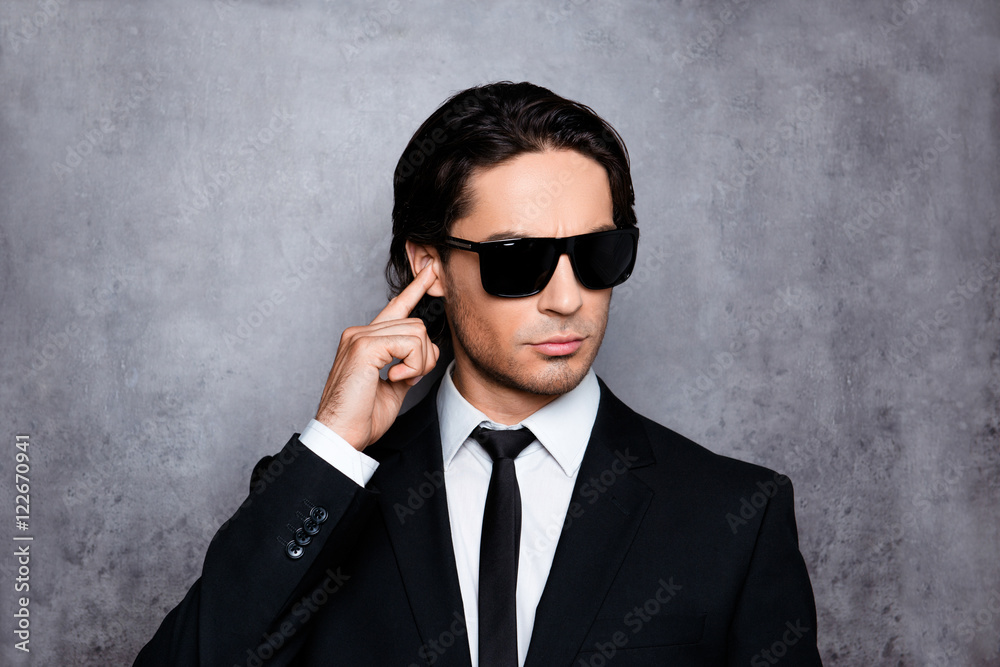 Portrait of handsome young security guard in black glasses Portrait of handsome young security guard in black glasses