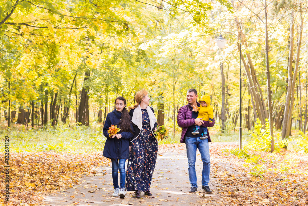 Happy family having fun outdoors in autumn park Happy family having fun outdoors in autumn park