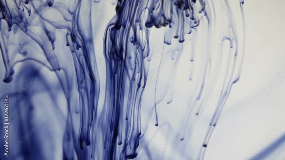 blue paint poured into clear water blue paint poured into clear water