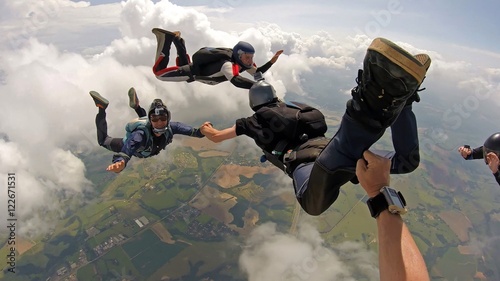 Skydiving point of view. Young and middle aged friends having fun