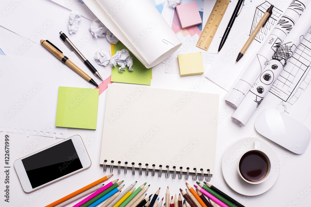 Desktop with blank notepad and cellphone Desktop with blank notepad and cellphone