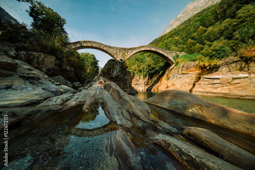 Panoramic Double arch stone bridge at Ponte dei Salti with waterfall, Lavertezzo, Verzasca, Canton Tessin. photo