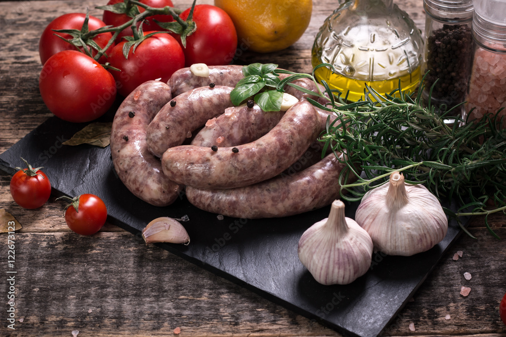 Fresh butcher cut meat assortment garnished with fresh rosemary on wooden table