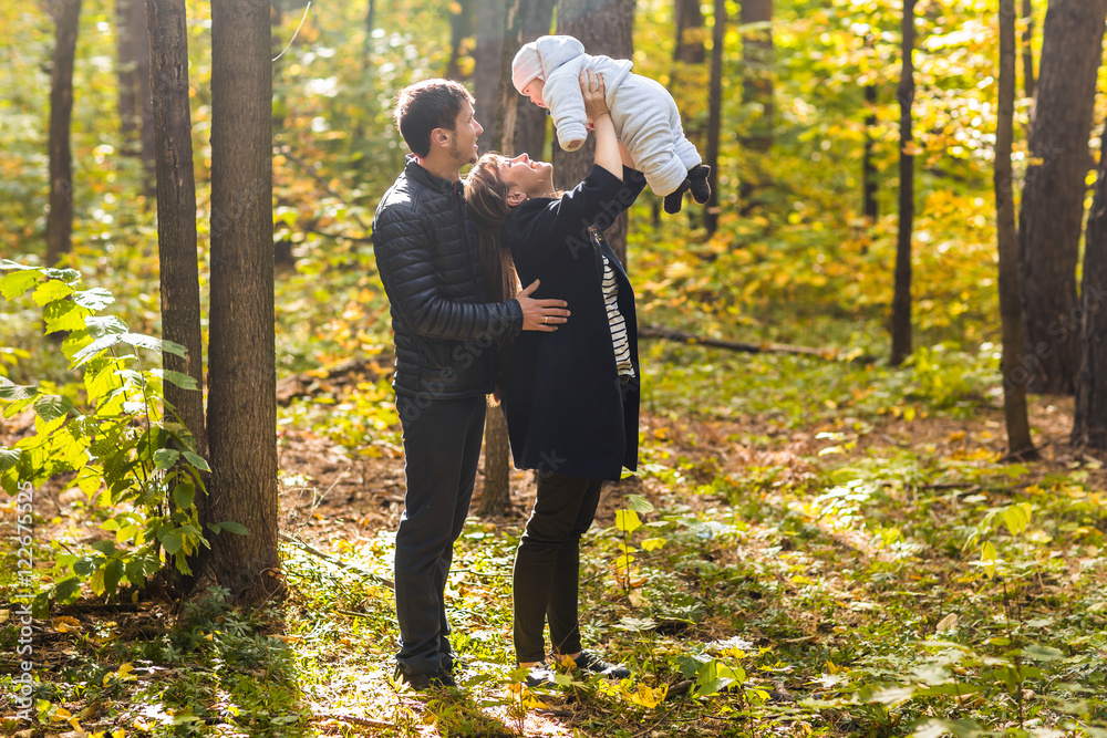 Happy family having fun outdoors in autumn park